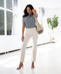 Woman wears the PLEIN PUBLIQUE ribbed collared top LA RIXY in white and dark blue.