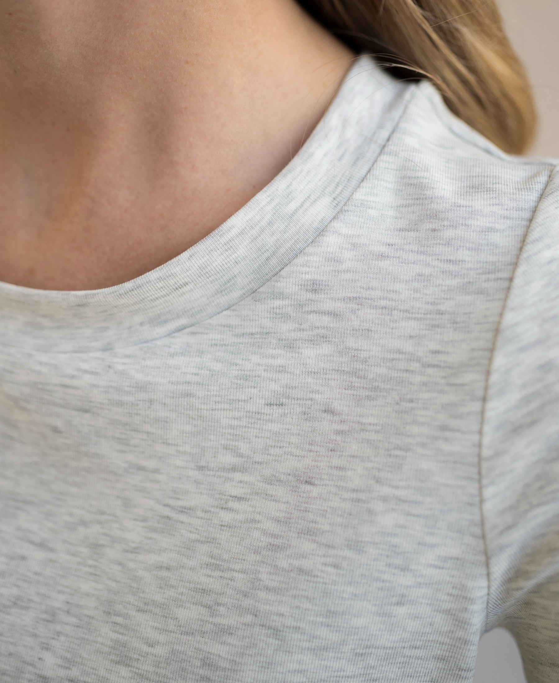 Close-up of a stretch short-sleeve T-shirt in feather grey, showing neck and shoulder.