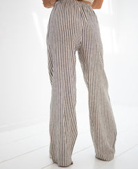 Striped linen-blend trousers in anthracite with black and white stripes, shown indoors.