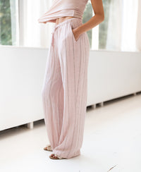 Striped linen-blend trousers LA SECONDE in pink from PLEIN PUBLIQUE, shown indoors with hand in pocket.