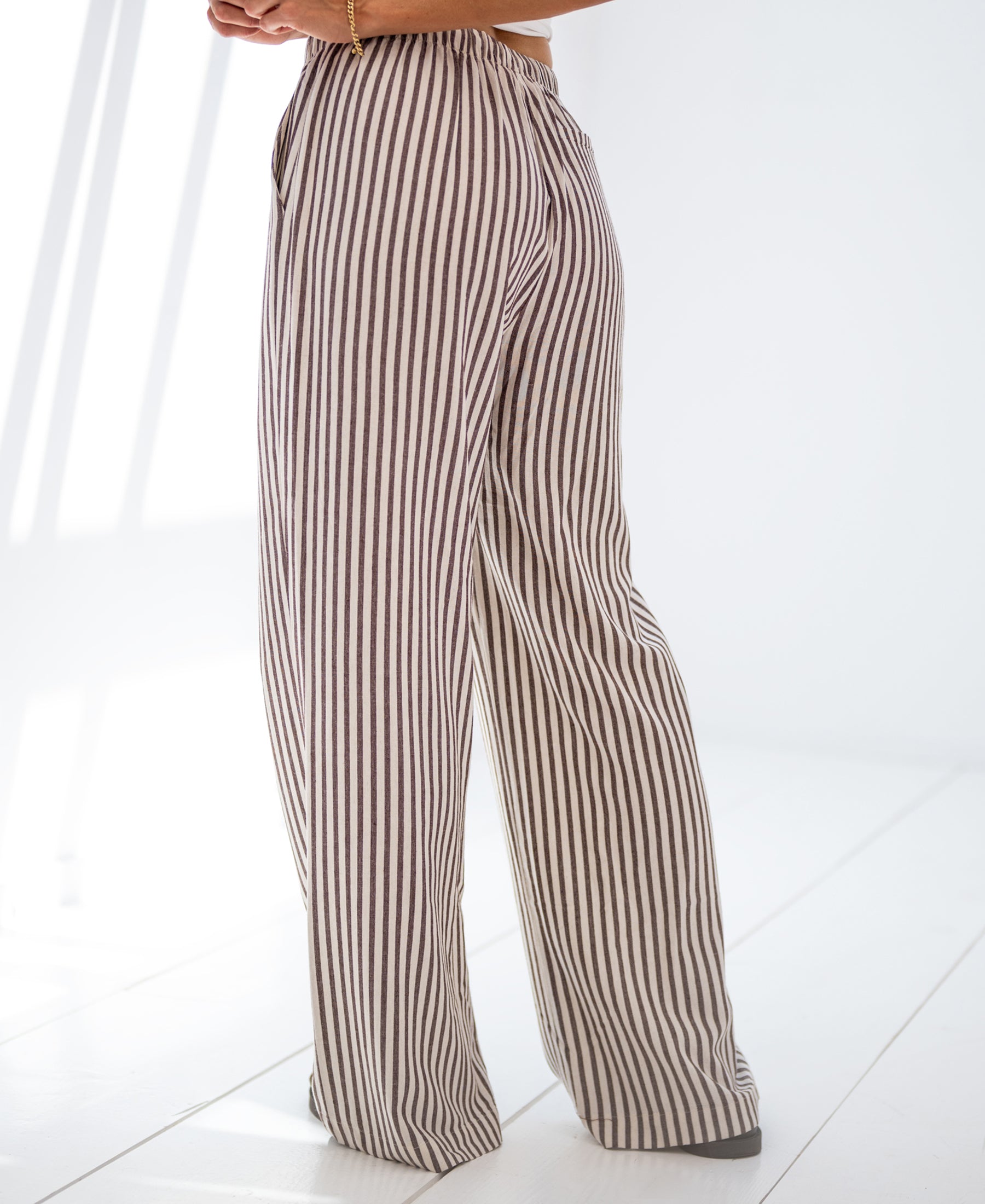 Striped linen-blend pants LA SECONDE Brown by PLEIN PUBLIQUE, shown standing on a white floor.