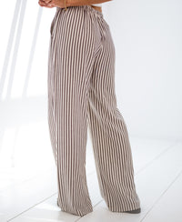 Striped linen-blend pants LA SECONDE Brown by PLEIN PUBLIQUE, shown standing on a white floor.
