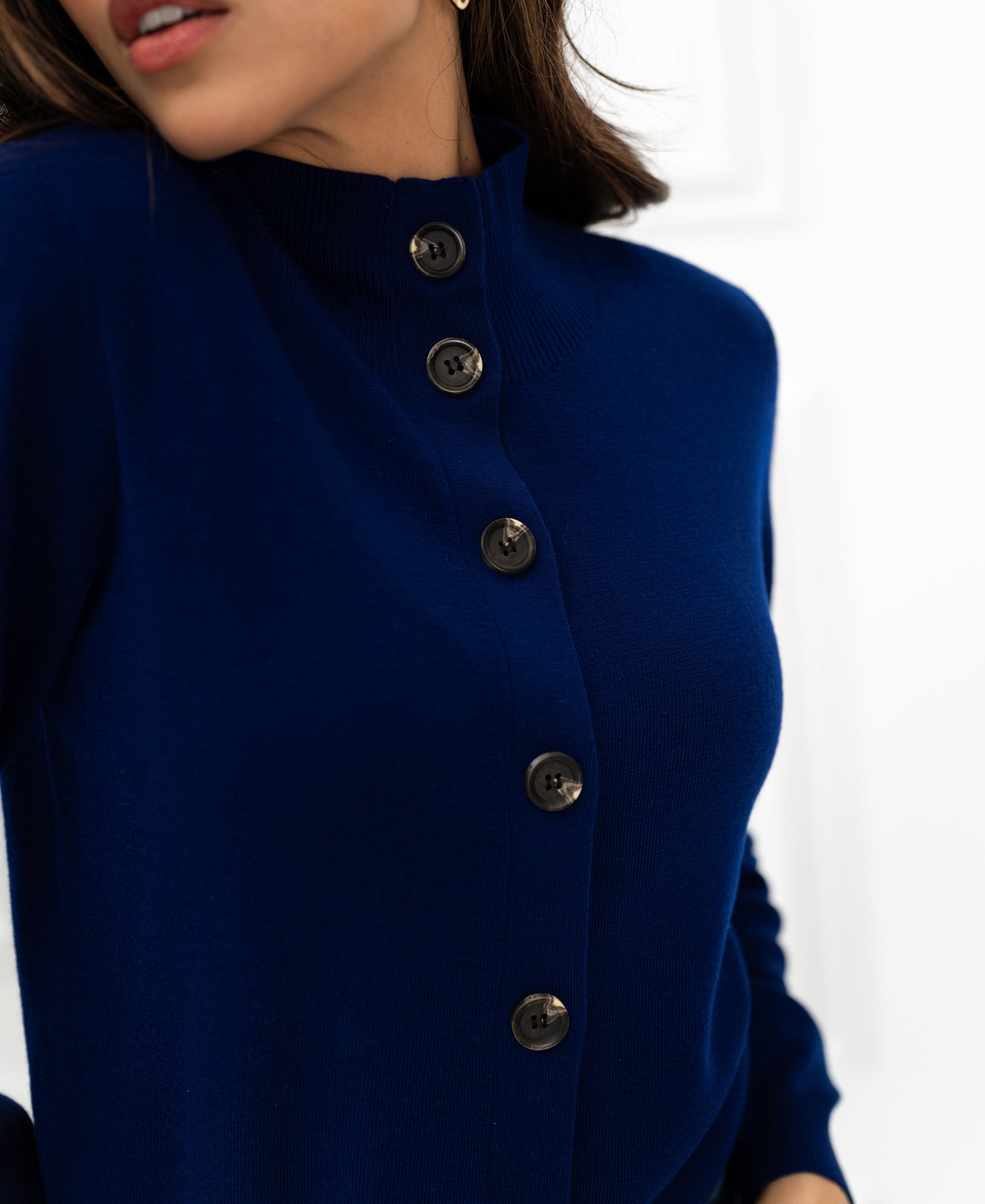 Merino wool turtleneck vest in navy blue by PLEIN PUBLIQUE, shown from shoulders to waist.
