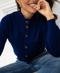 Marine blue Merino wool vest with collar, shown worn by a smiling woman.