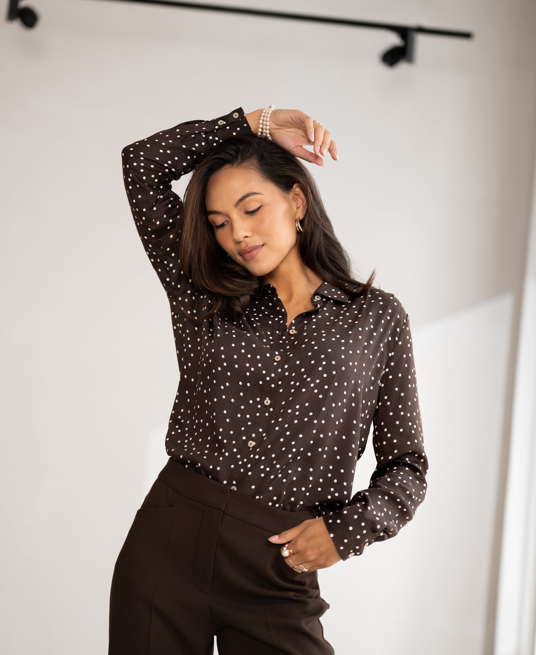 PLEIN PUBLIQUE LA SEZANNE chocolate-ivory polka dot blouse shown against a neutral background.
