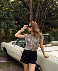 Black LA MADDY short by PLEIN PUBLIQUE, shown worn outdoors.