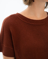 Close-up of a short-sleeved, rust-colored linen summer sweater.