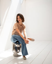 Linen summer sweater LE SOLEIL in soft camel by PLEIN PUBLIQUE shown in a bright room.