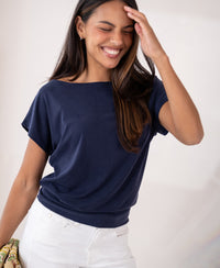Woman wearing a ribbed boat neck T-shirt in dark blue by PLEIN PUBLIQUE.