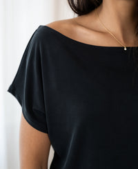 Charcoal rib boat neck T-shirt, shown from shoulders down.
