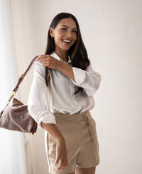 Woman wears the Dunne oversized blouse made from silk by Plein Publique.