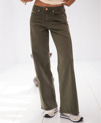 Wide-leg jeans in army green, shown on a person standing on a light-colored floor.