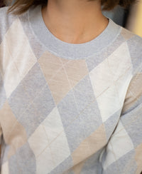 Light grey melange argyle merino wool sweater, shown from shoulders to neck.