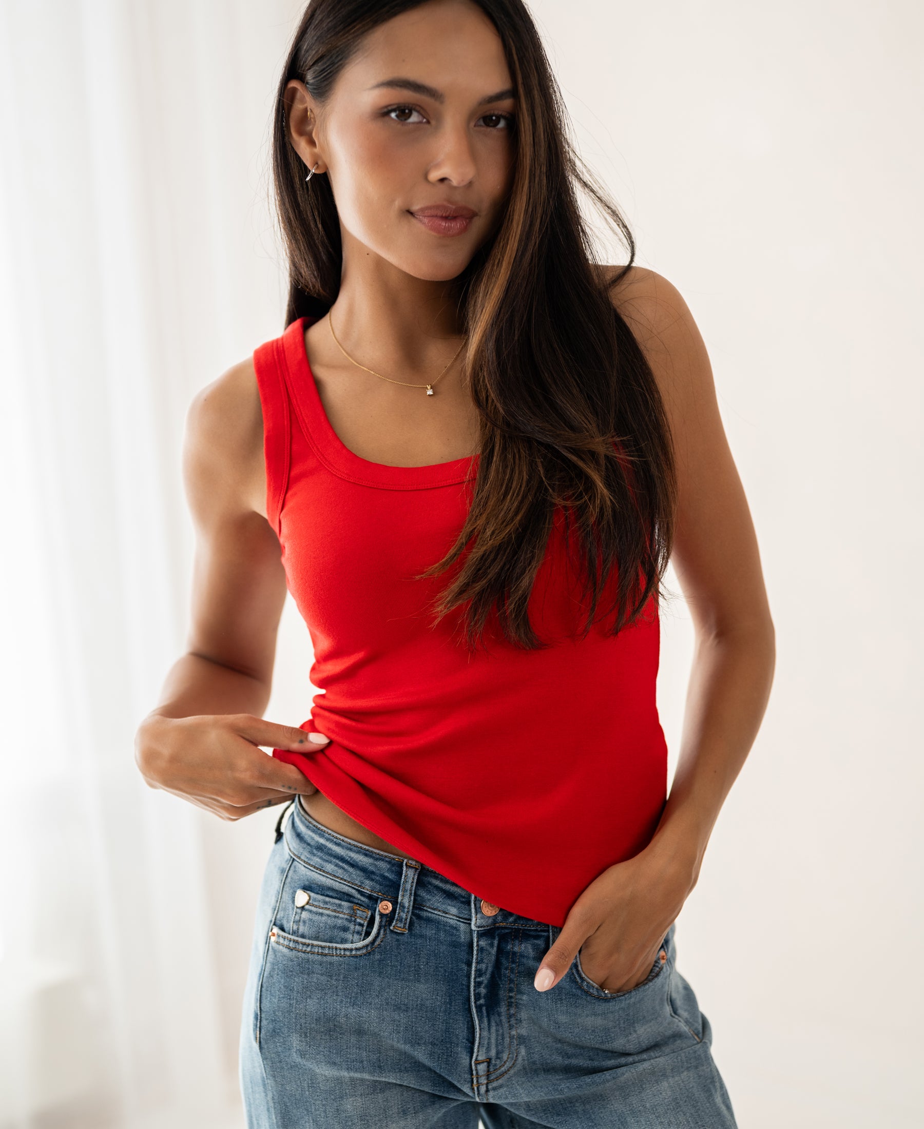 Red Luxe & Soft Top by PLEIN PUBLIQUE shown on a woman with long dark hair in a bright room.
