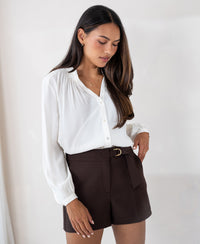 Chocolate brown PLEIN PUBLIQUE LA TRENTE shorts against a light plain background.