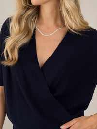 Navy blue PLEIN PUBLIQUE LES TROIS wrap sweater shown on model.