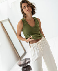 Luxe & soft olive green top by PLEIN PUBLIQUE shown in a bright room.