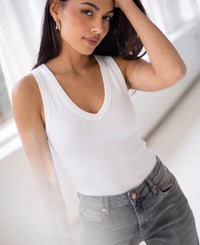 Luxe & soft white LA VALE top by PLEIN PUBLIQUE, shown worn by a woman with long dark hair.