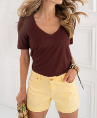 Woman in a brown bamboo T-shirt indoors.