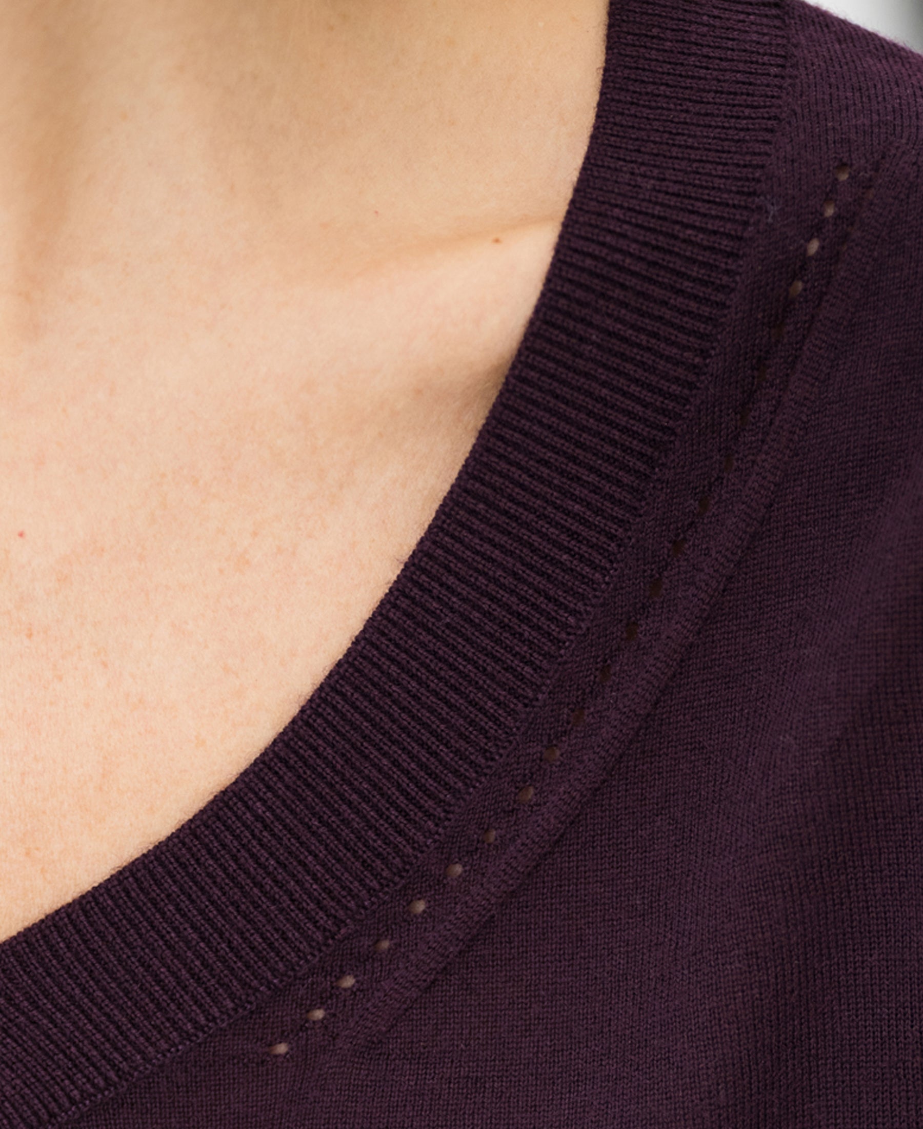 Close-up of neckline in the PLEIN PUBLIQUE Merino V-neck sweater "LA VILLE" in aubergine, finely knitted and soft.