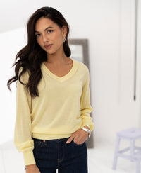 Merino wool V-neck sweater in soft yellow by PLEIN PUBLIQUE, front view.