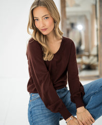 Brown Merino wool V-neck sweater "LA VILLE" by PLEIN PUBLIQUE, shown worn indoors, front view.