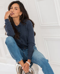 Indigo blue women's polo collar vest by PLEIN PUBLIQUE, LES VINGT collection, shown while seated.