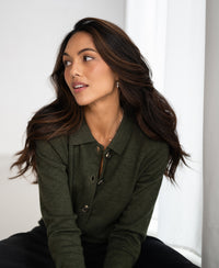Green collared vest made from soft natural materials shown in soft natural light.