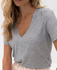 Woman wearing a grey melange Lyocell T-shirt, shown from the front.