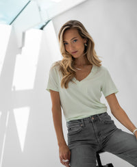 Pastel green Lyocell T-shirt in a modern space.