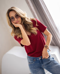 Woman wearing the PLEIN PUBLIQUE Stretch Short Sleeve T-shirt in Chili red indoors.