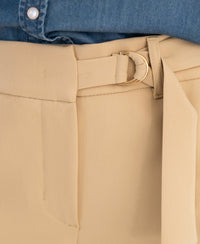 Close-up of beige LA WENDE Pants by OVERIG with asymmetric belt and gold buckle.