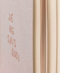 Close-up of the Plein Publique natural notebook with dotted cream pages and visible cover text.