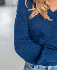 PLEIN PUBLIQUE Merino V-neck sweater LA VICTORIA in blue, upper body view.
