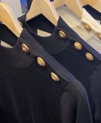 Three dark blue merino wool sweaters by PLEIN PUBLIQUE hang on wooden hangers.