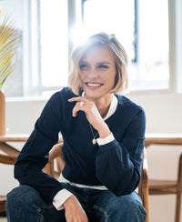 PLEIN PUBLIQUE's Merino Wool Sweater LA COEUR in dark blue shown in natural light.