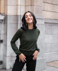 Merino wool LA COEUR sweater in bottlegreen by PLEIN PUBLIQUE, shown outdoors.