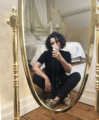 Black merino wool sweater shown on person in mirror selfie.
