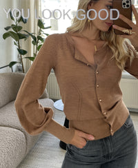 Woman taking a mirror selfie wearing a gold PLEIN PUBLIQUE LA FRAGANCE cardigan. "YOU LOOK GOOD" appears above her.