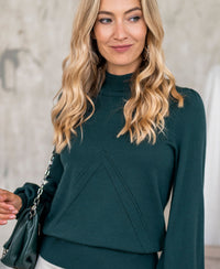 Dark green turtleneck sweater by PLEIN PUBLIQUE, shown indoors.