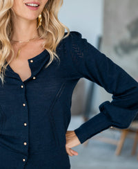 Woman wearing the PLEIN PUBLIQUE LA FRAGANCE navy blue and gold cardigan.